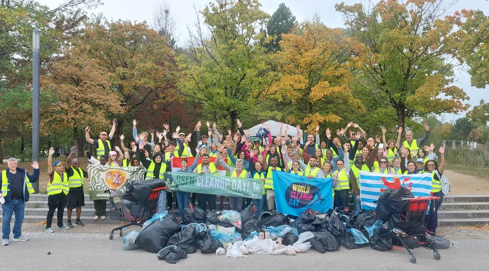 Volunteers in yellow vests with full bags at World Cleanup Day Kirchberg in Central Park Luxembourg